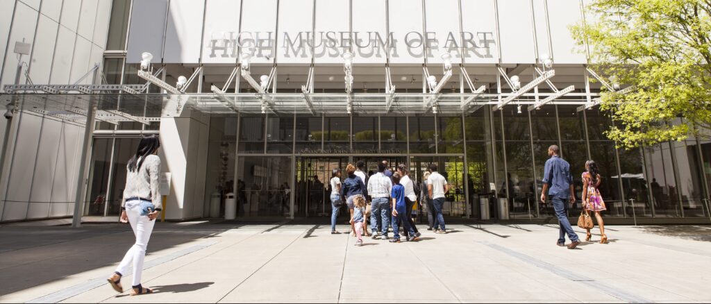 People walking into the entrance of the High Museum of Art.